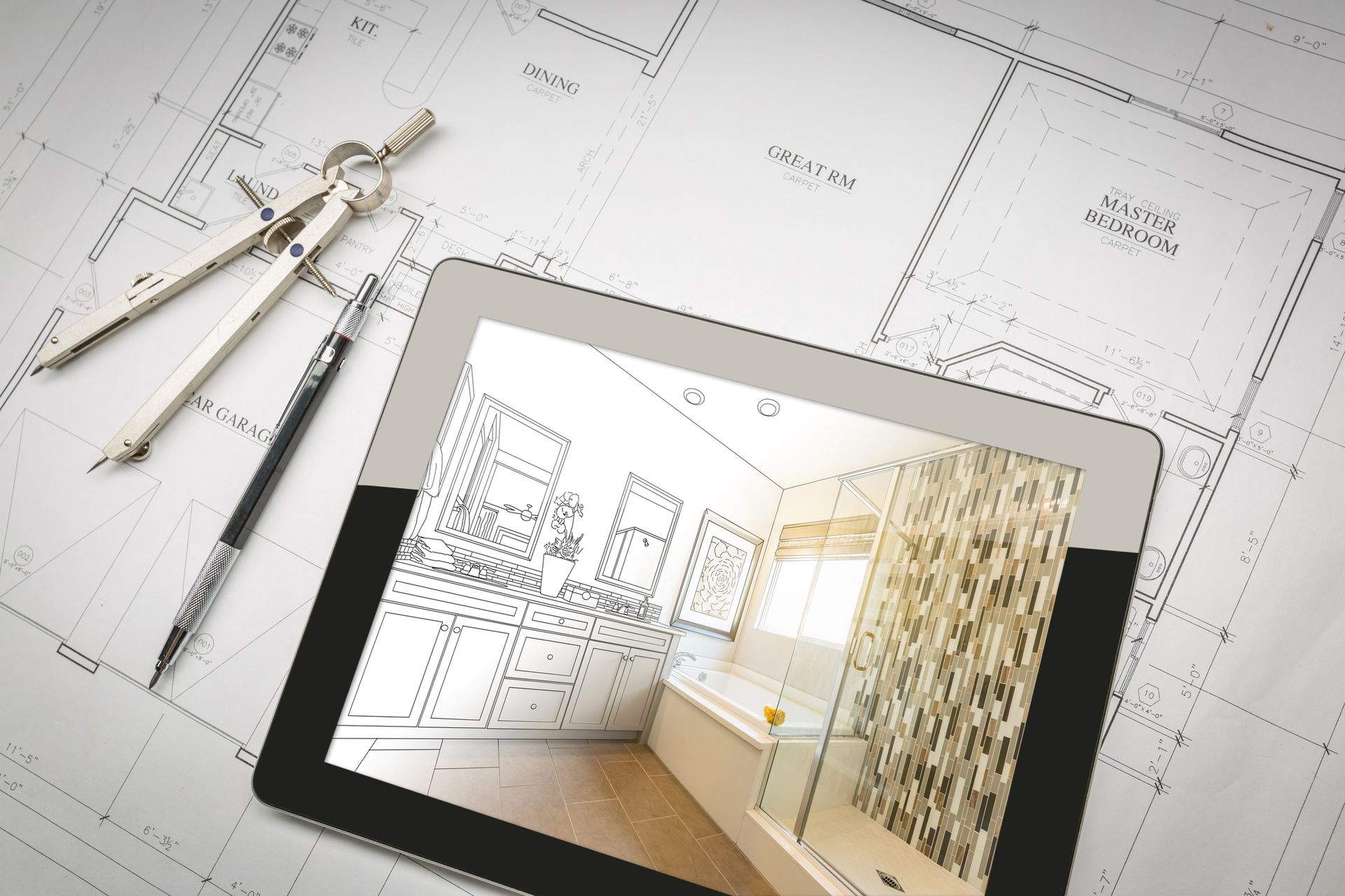 Architectural drafting desk with blueprints, compass tools, and a tablet showing a room interior design layout
