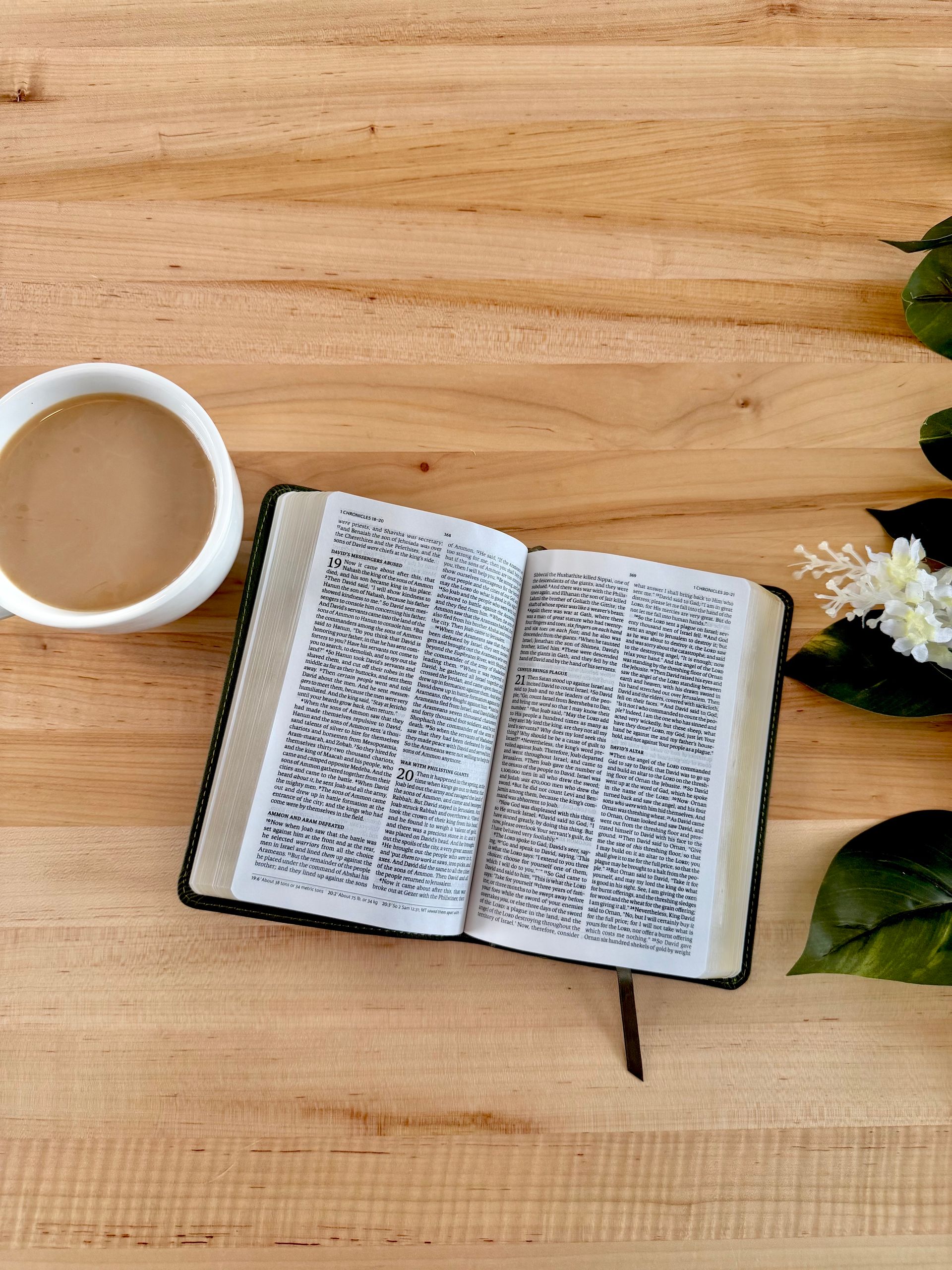 An open bible with a pencil on top of it