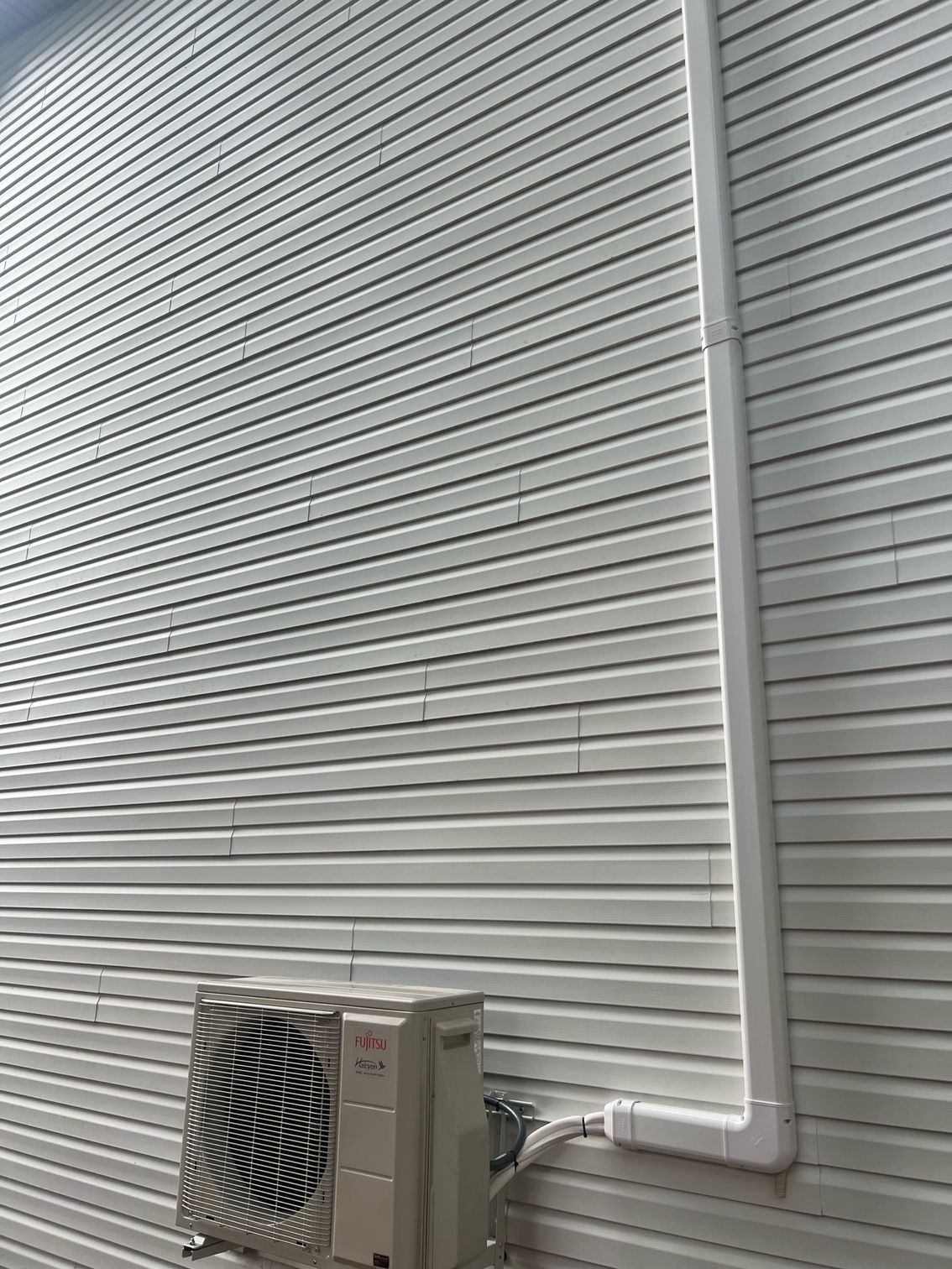 an air conditioner is installed on the side of a house .