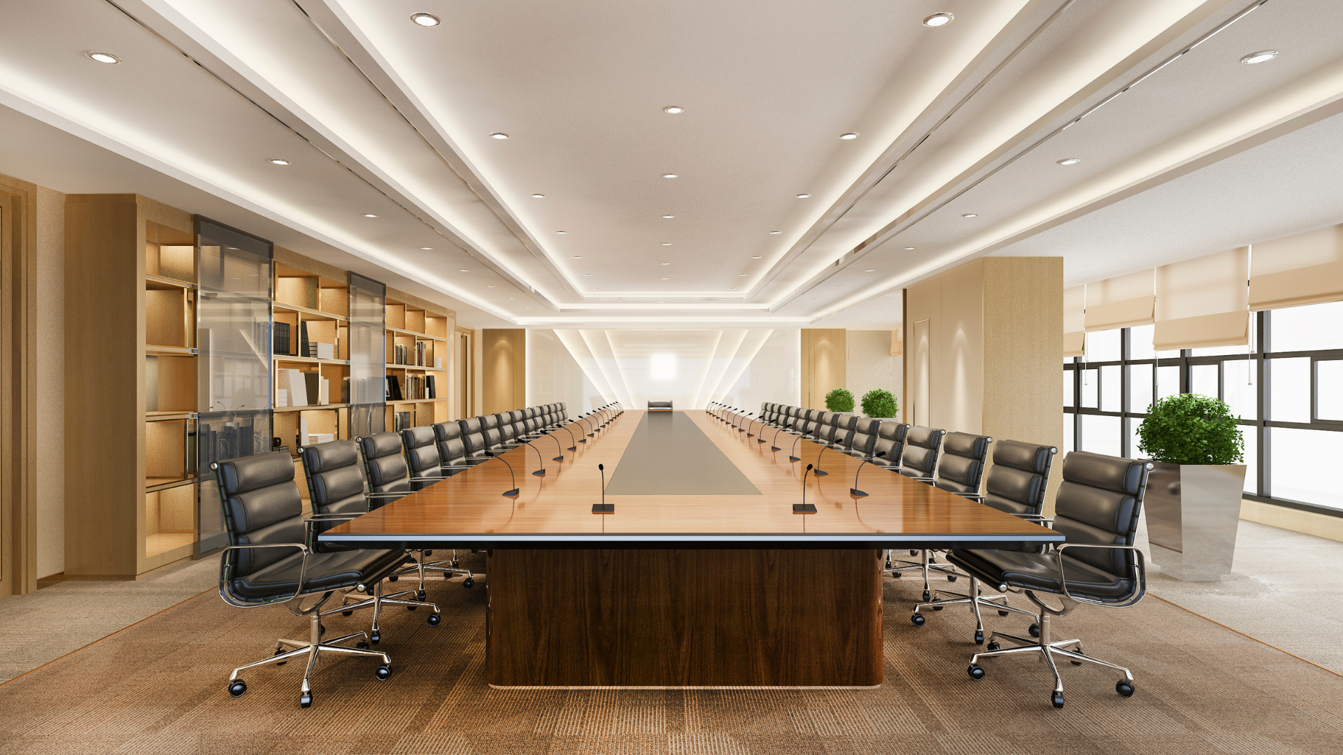 A large conference room with a long wooden table and chairs.