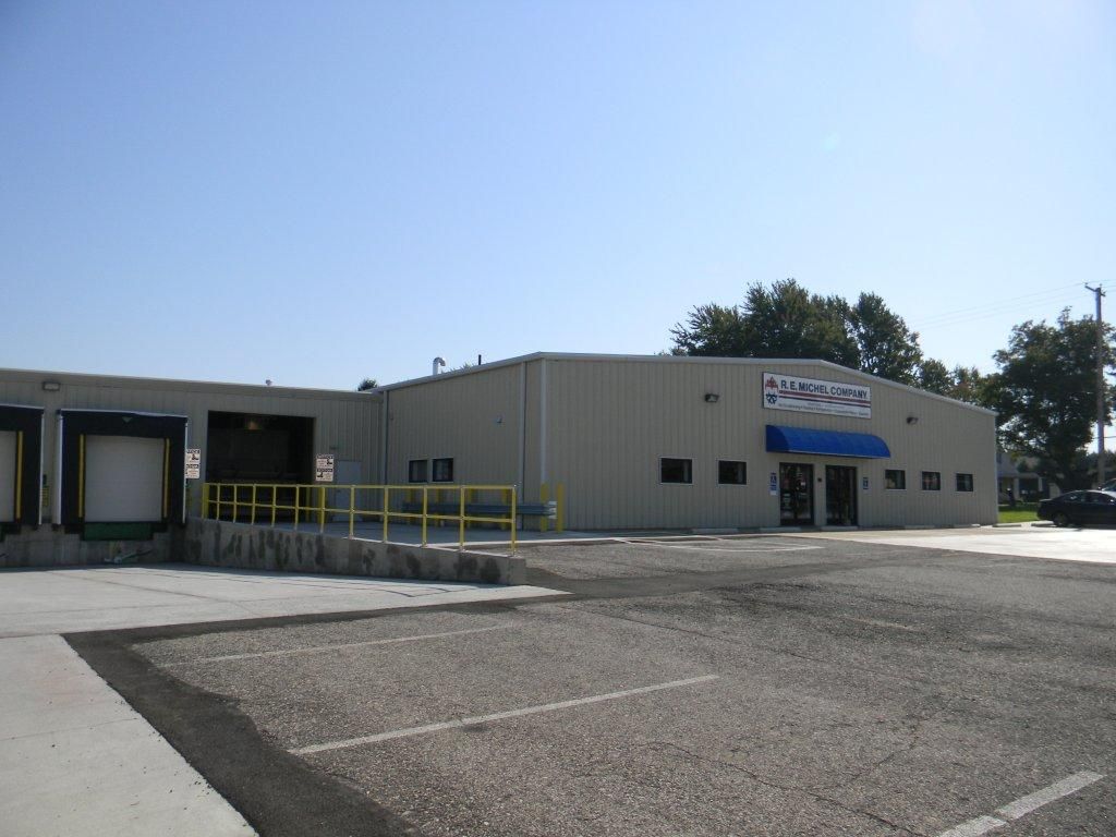 A large building with a blue awning that says ' warehouse ' on it