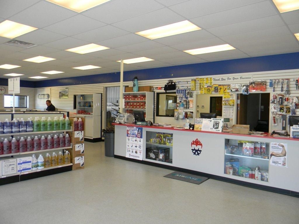 The inside of a store with lots of shelves and a counter