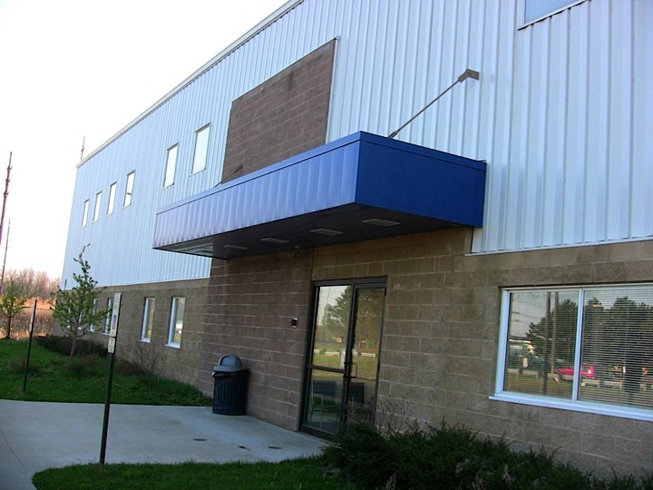 A large building with a blue awning over the entrance
