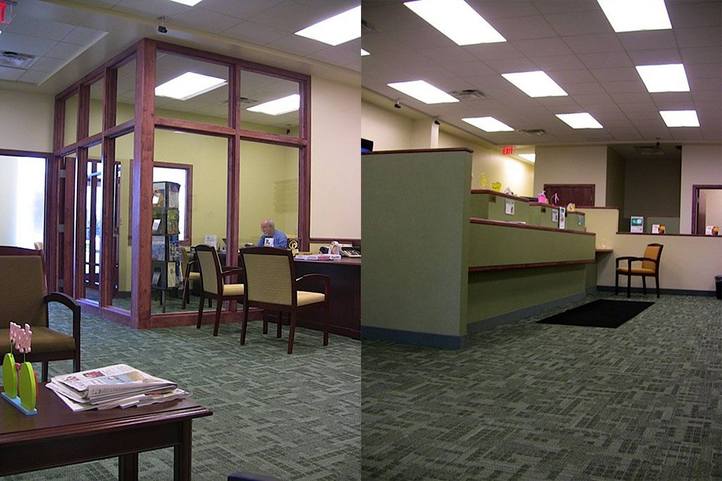 A man sits at a desk in a waiting room