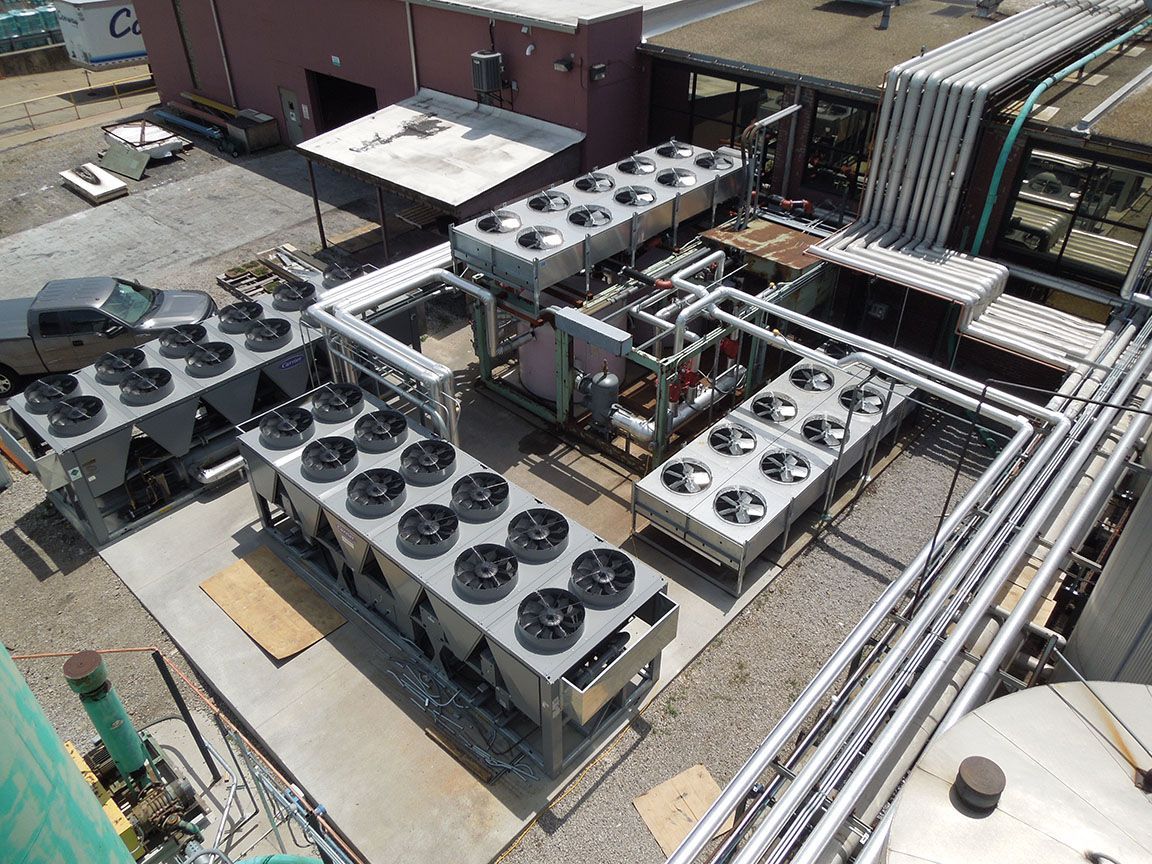 An aerial view of a factory with a lot of fans and pipes.