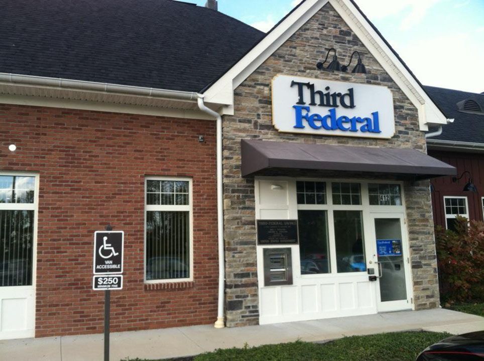 A brick building with a sign that says third federal