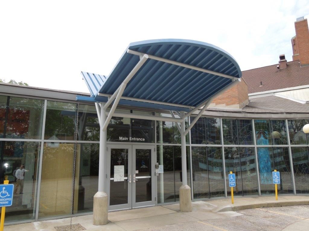 A building with a blue awning over the entrance