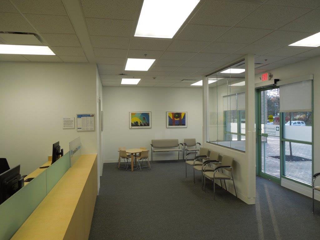 A waiting room with a table and chairs in it