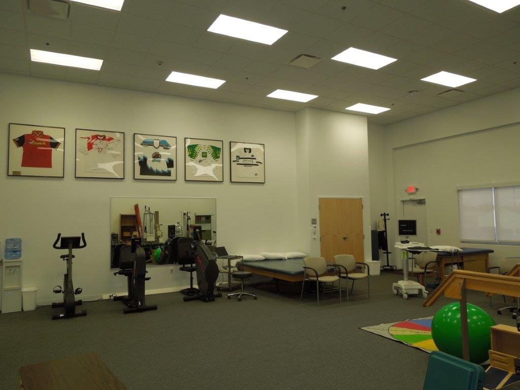 A large room with a lot of exercise equipment in it