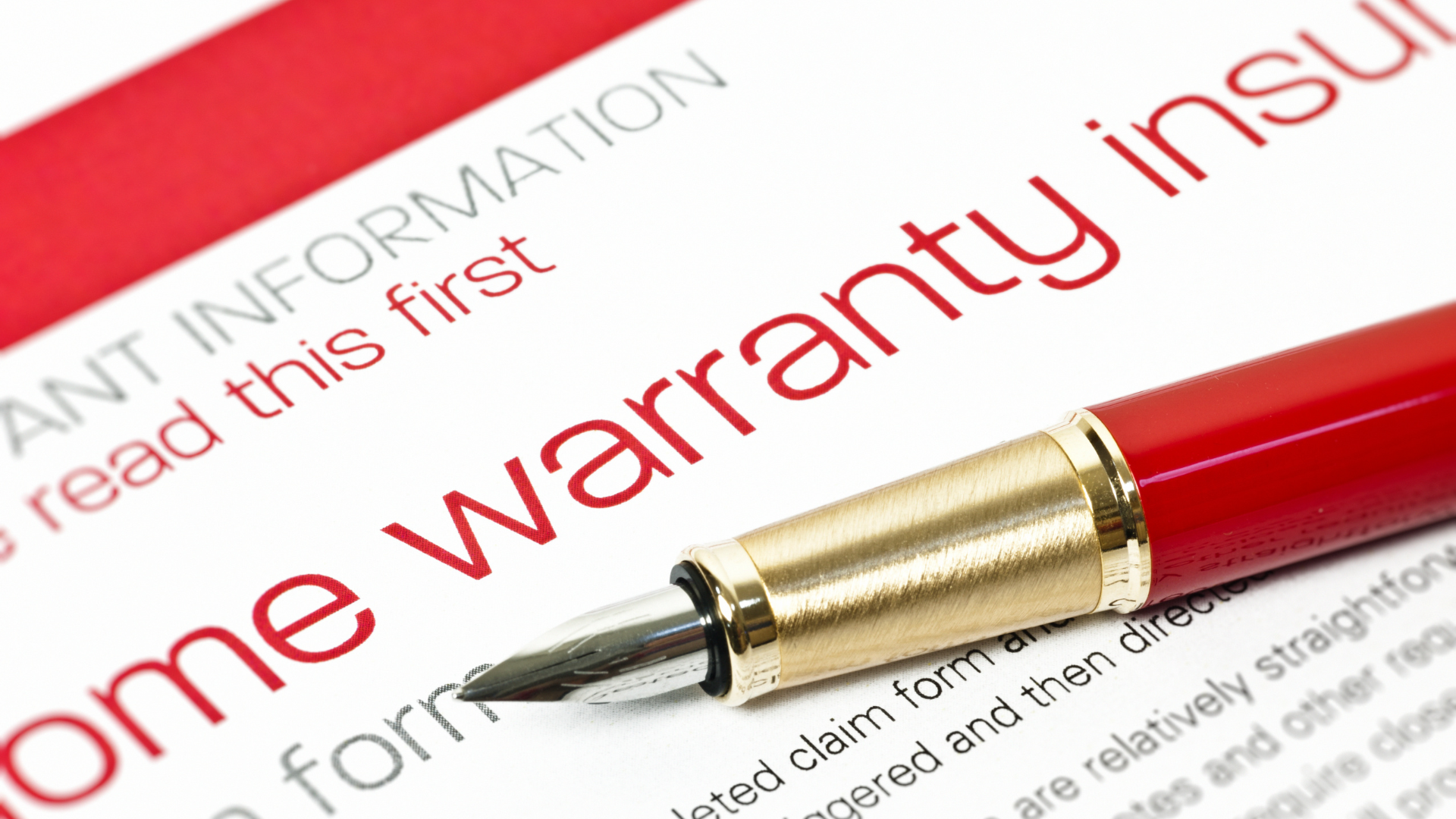 A pen is sitting on top of a home warranty form.