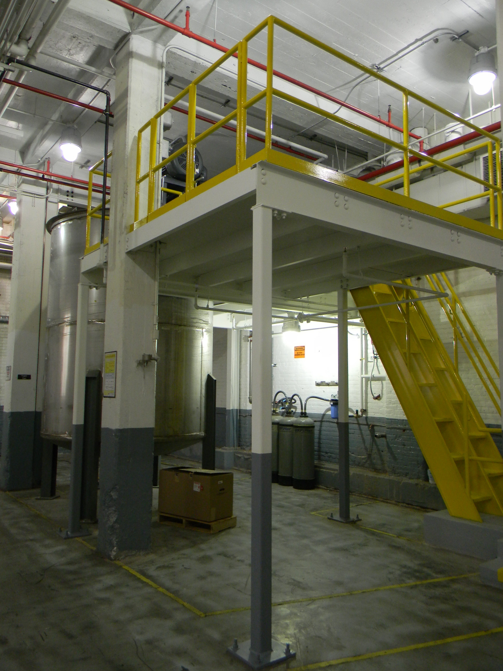 A warehouse with a yellow railing and stairs