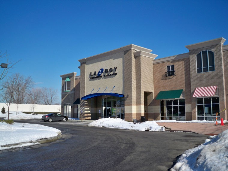 A large building with a car parked in front of it