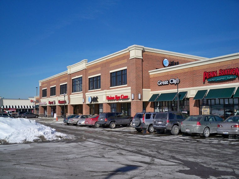 A brick building with a lot of cars parked in front of it