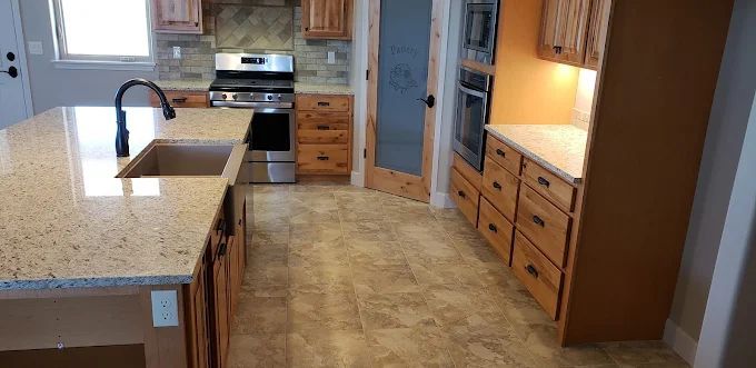 Kitchen with wooden cabinets, granite countertops, and stainless steel appliances.