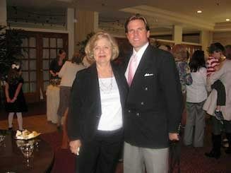 A man and a woman are posing for a picture in a room.