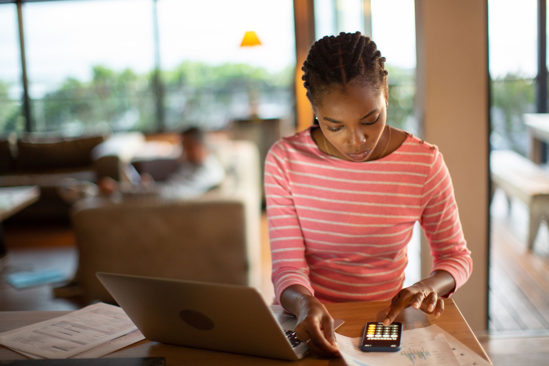 Young woman working on home finances Young woman working on home finances