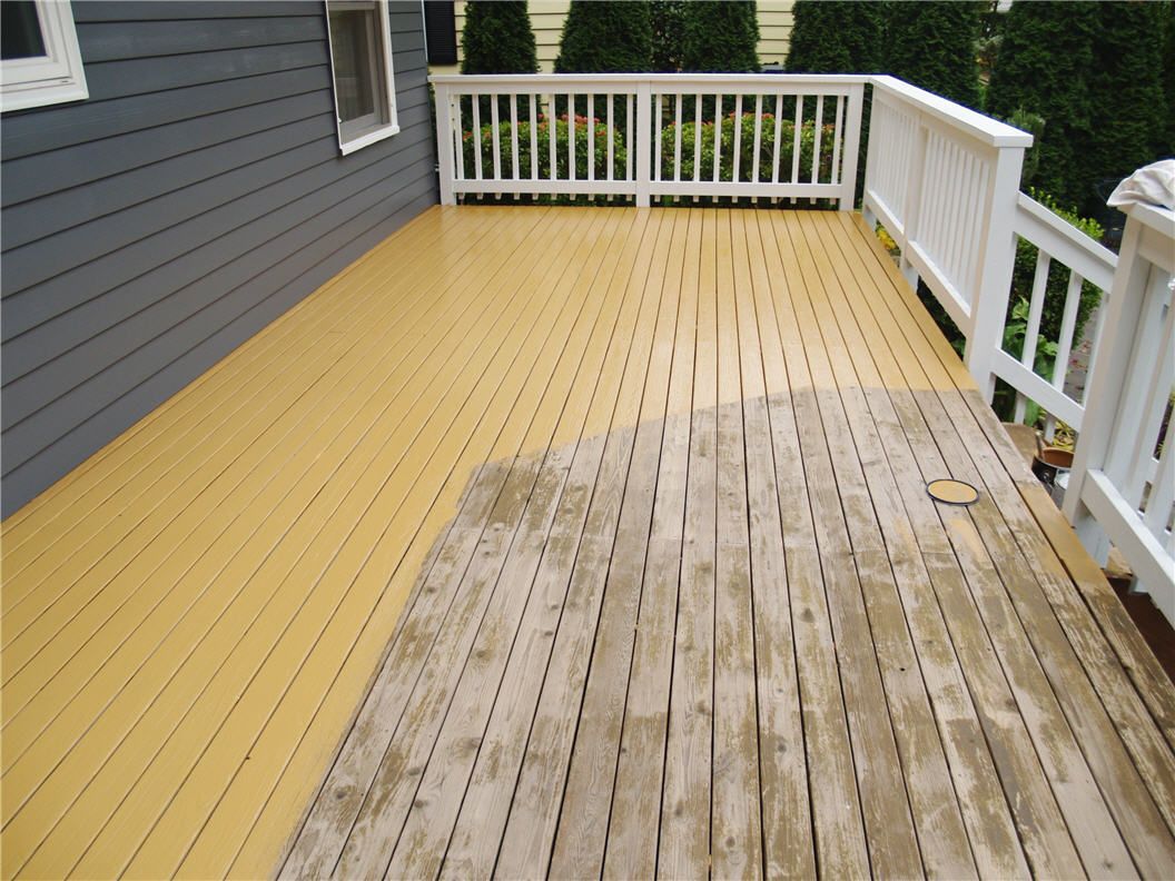 An outdoor deck painted in a natural wood finish, showcasing its rich grain pattern and warm hues.