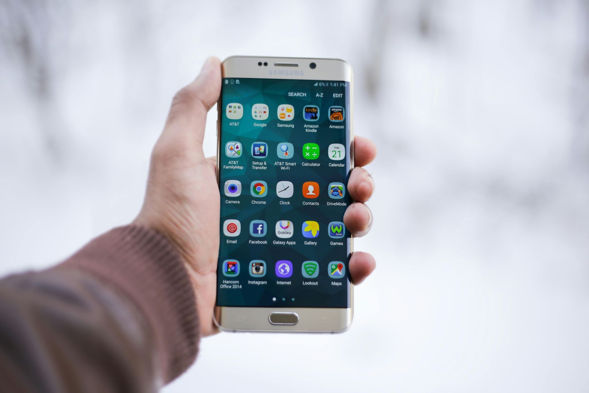 A person is holding a cell phone in their hand.