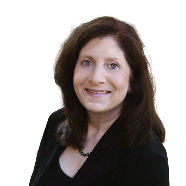 A woman wearing a black jacket and necklace smiles for the camera