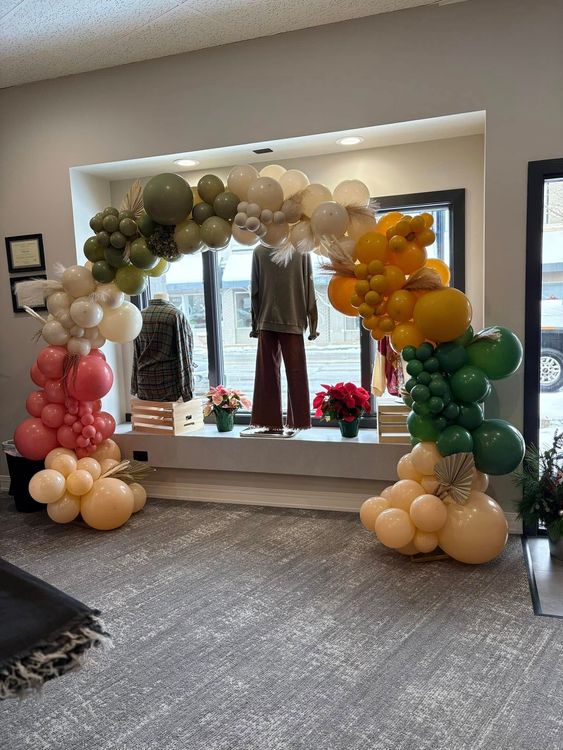 Woman in brown fur coat, black hat, and white boots poses dramatically, angled against a white background.