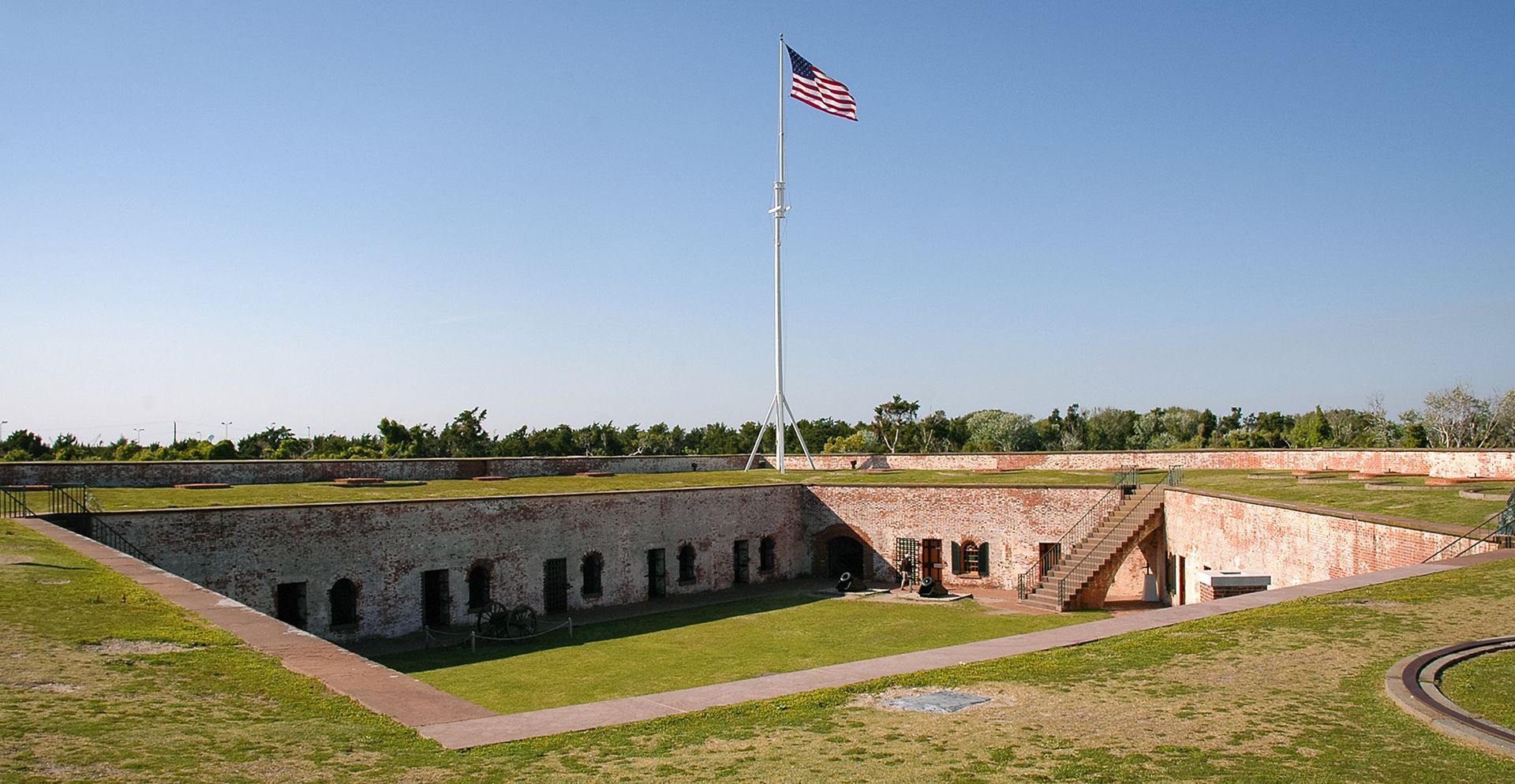 An american flag is flying over a brick building
