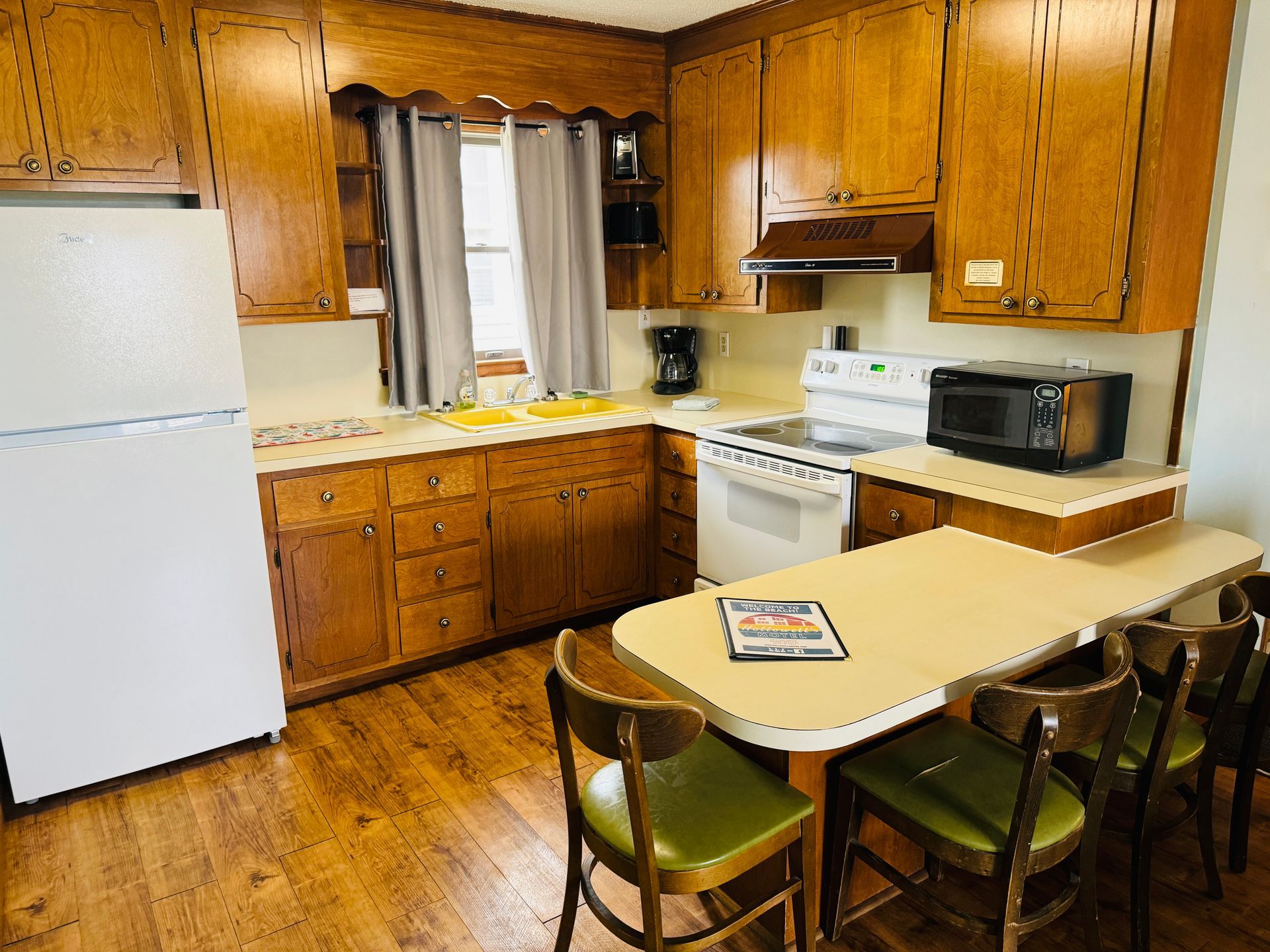 A kitchen with wooden cabinets and a white refrigerator