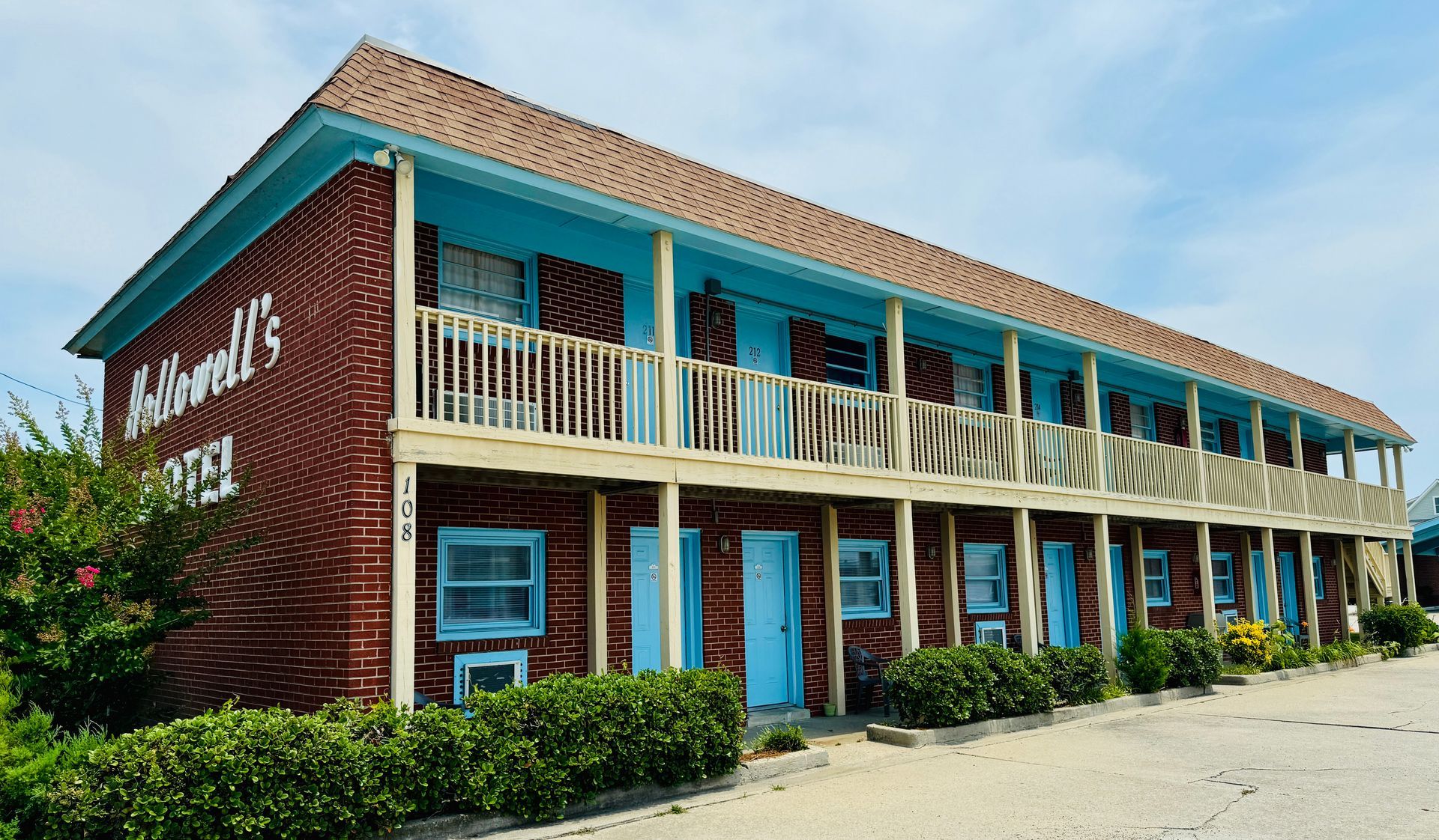 A large brick building with blue windows and balconies.
