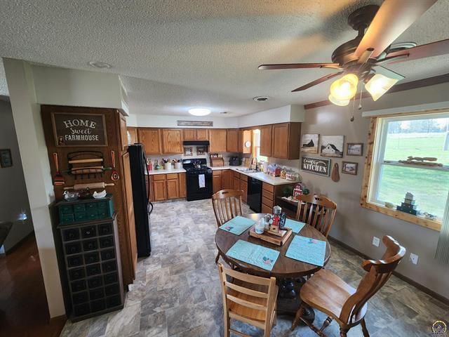 A dining room with a round table and chairs.