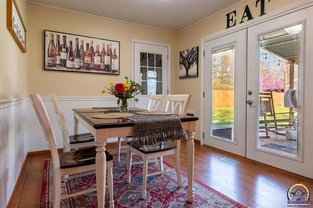 A patio with a lot of furniture and lights at night.