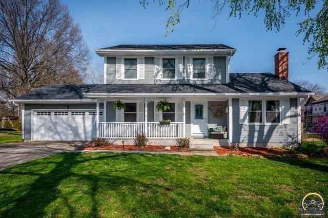A vase of flowers is sitting on a table next to a window.