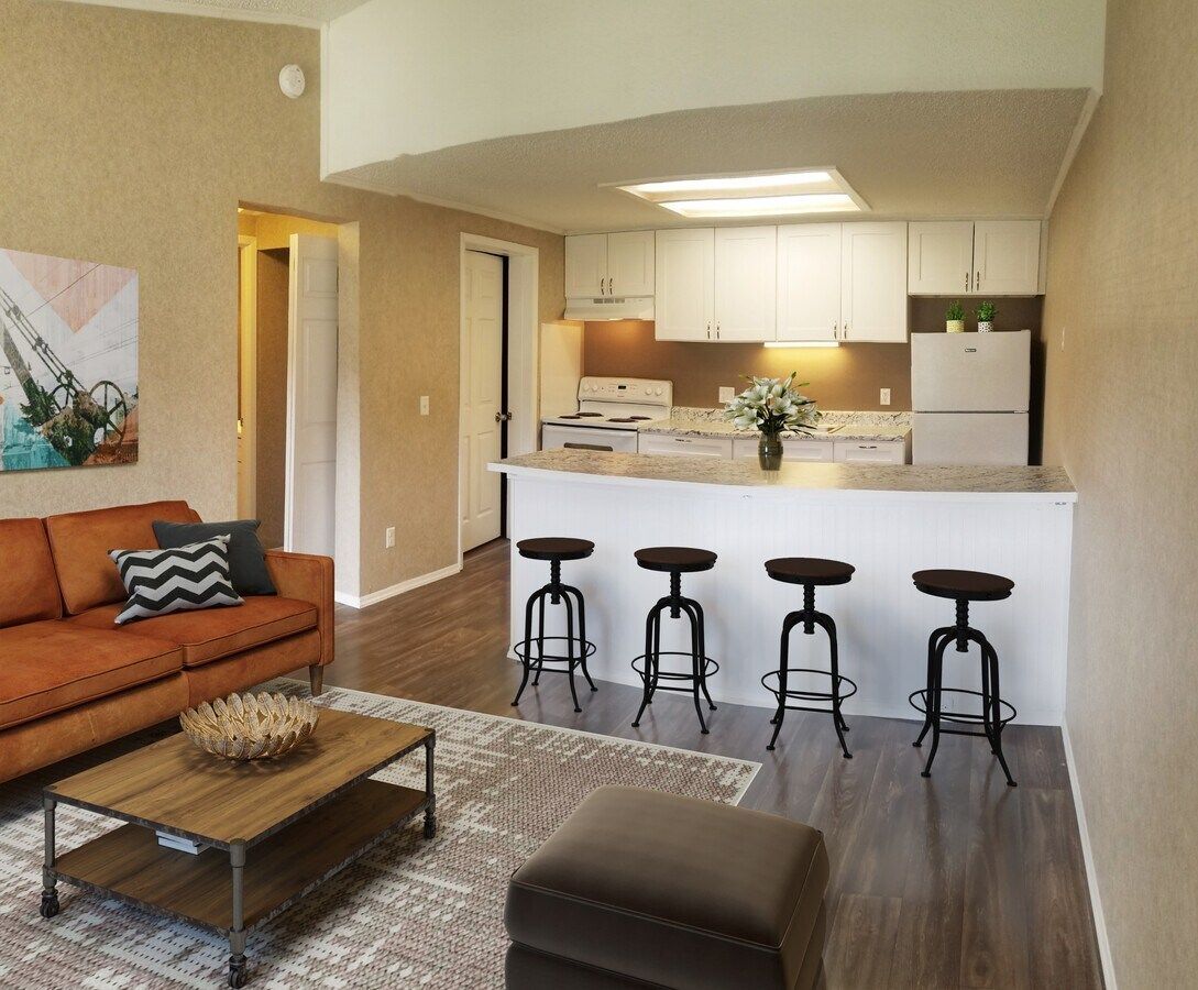 A living room with a couch , coffee table and stools