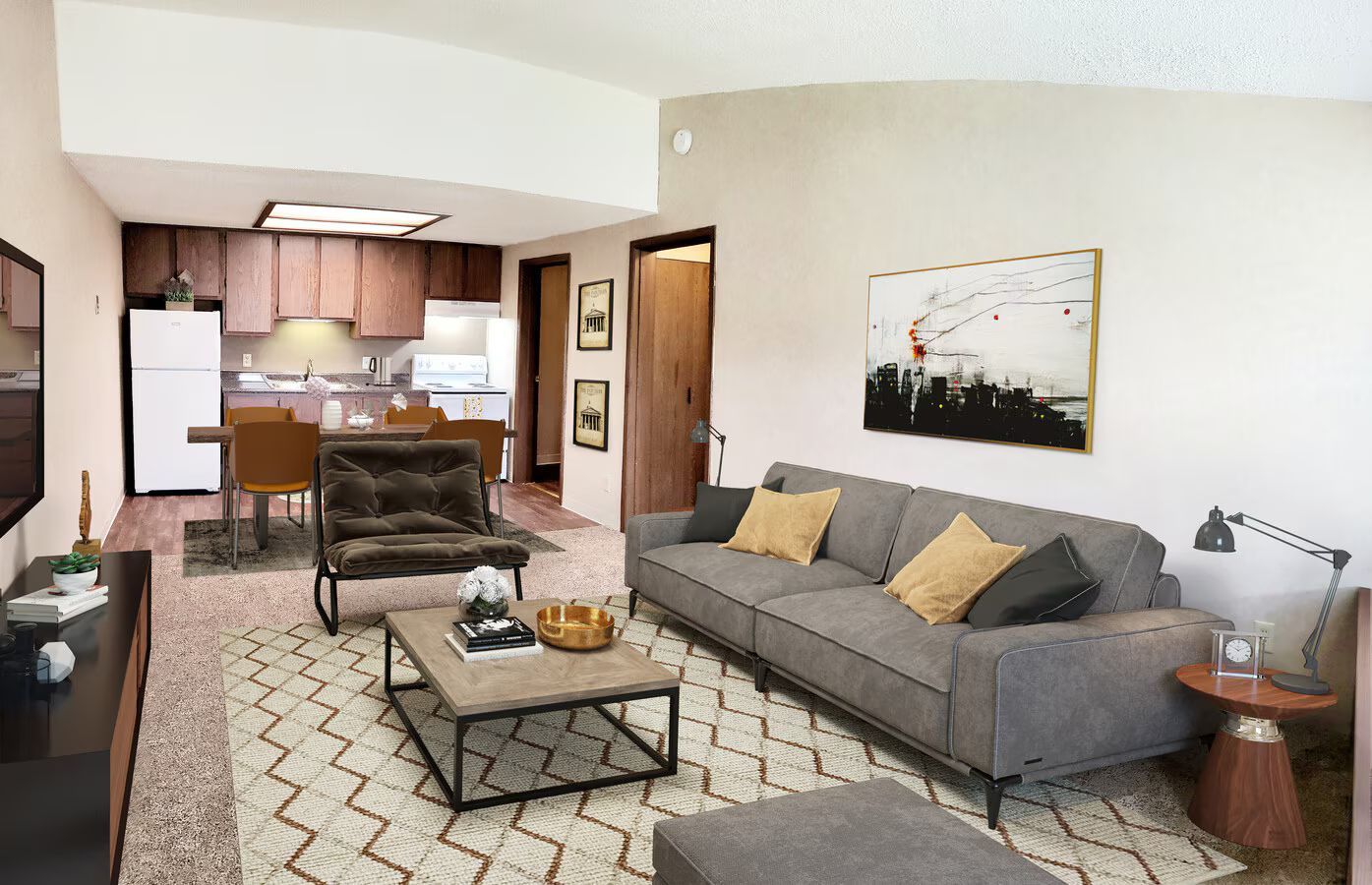 A living room with a couch , coffee table , chairs and a television.