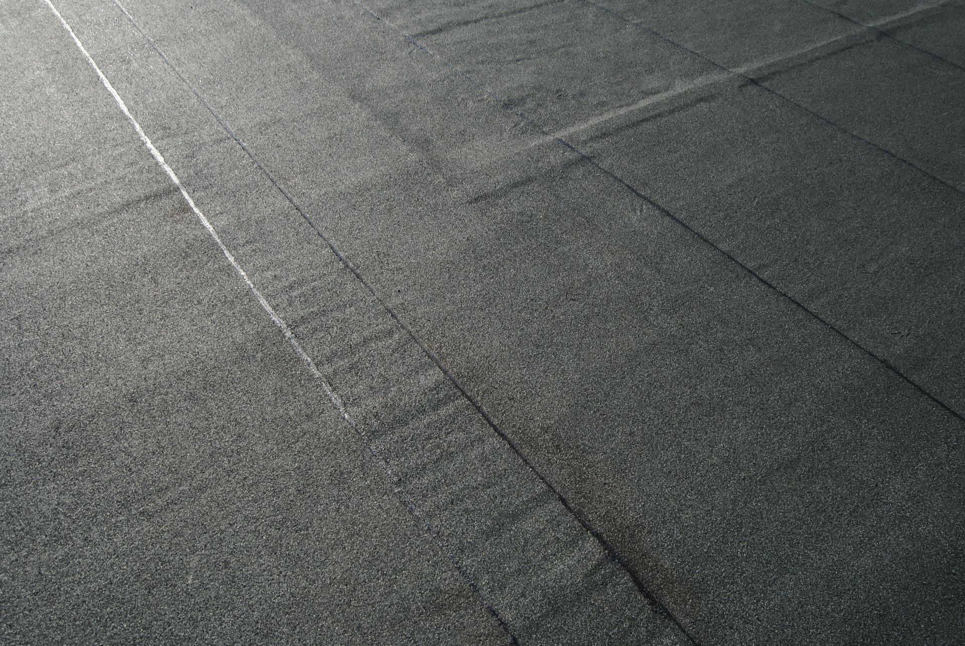 A close-up view of a waterproofing membrane installed on a  flat roof.