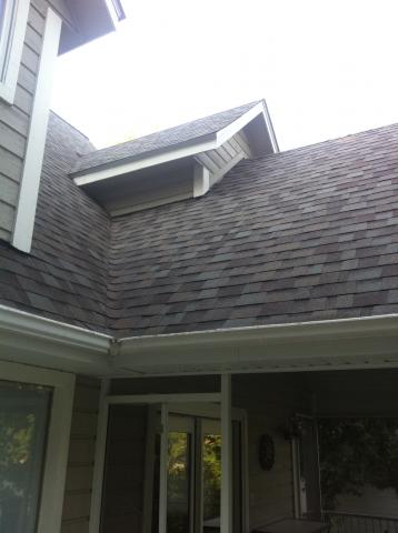 A house with a roof that has shingles on it