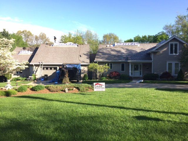A large house with a large lawn in front of it
