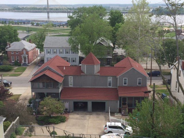 An aerial view of a house with a red roof