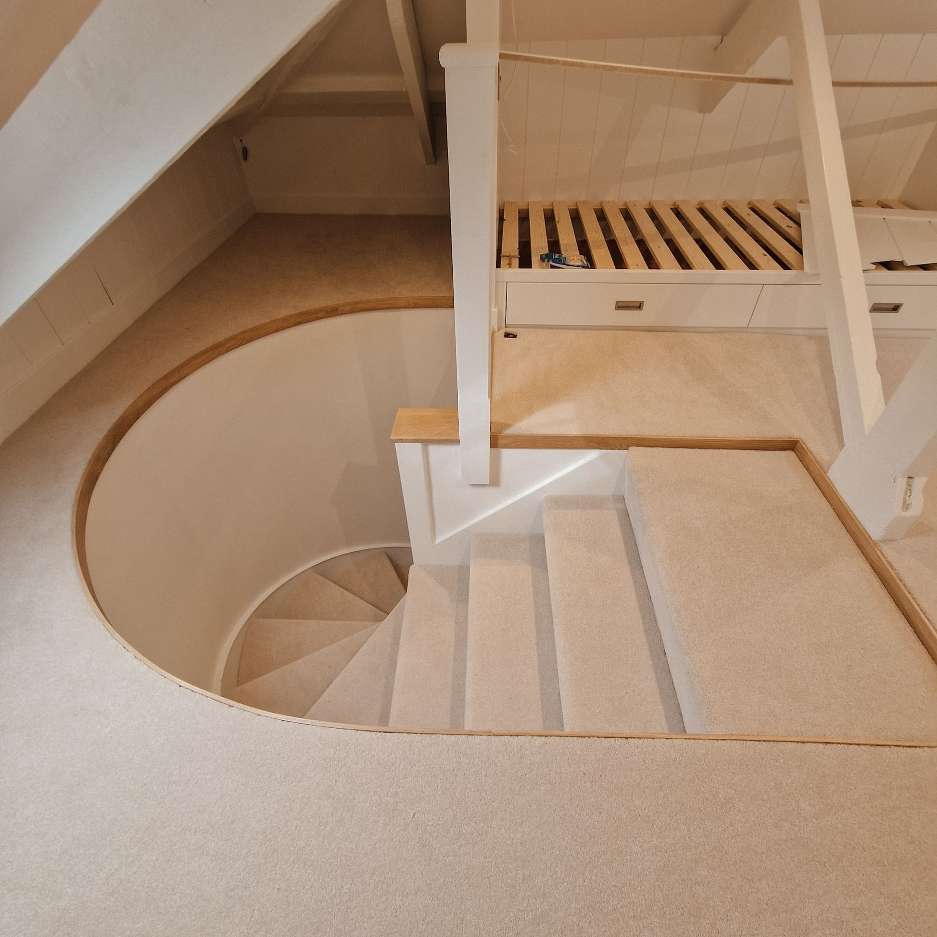 Unusual round enclosed staircase fully fitted in cream capet in Salcombe