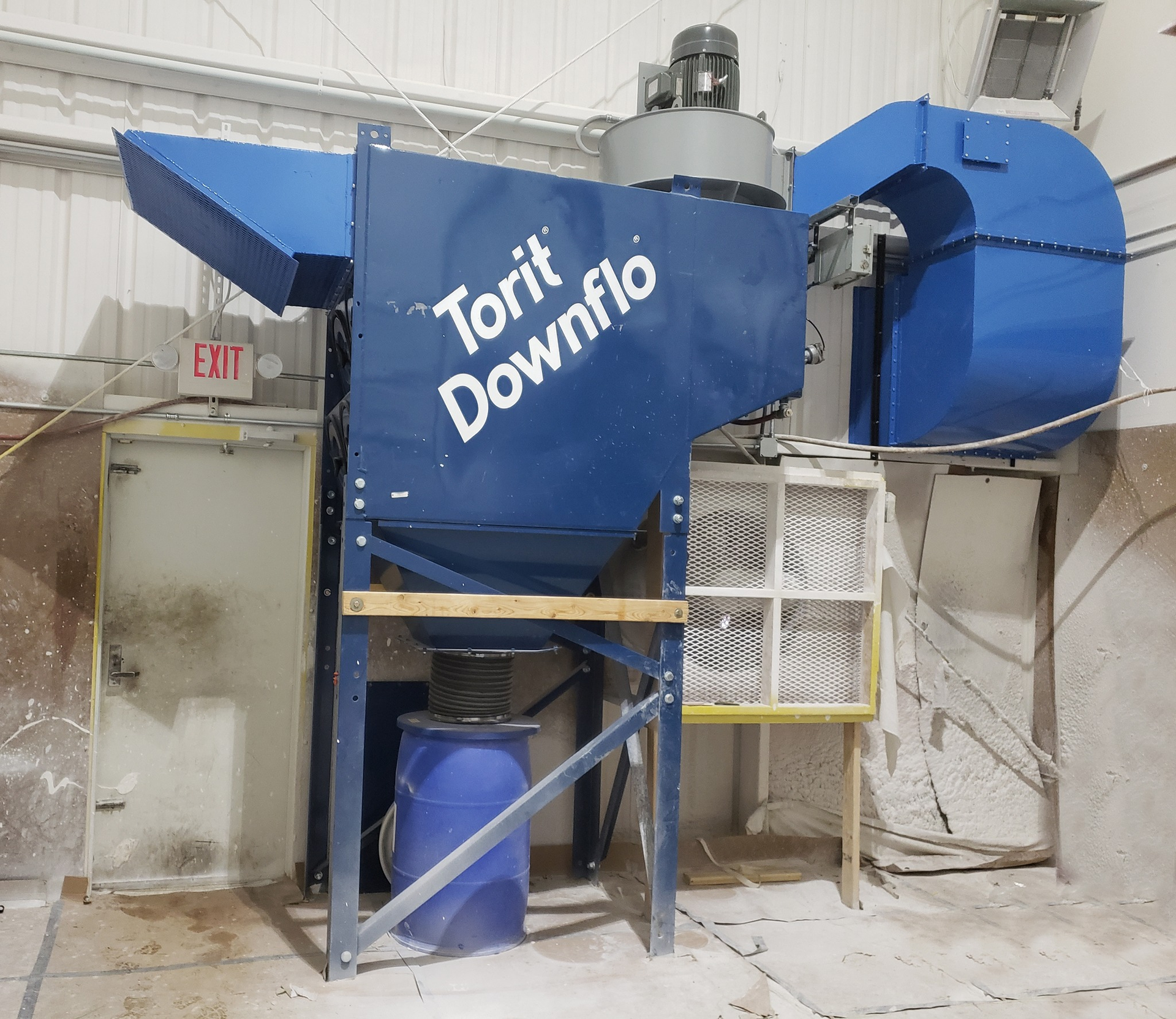 Blue Torit Downflo dust collection system in a factory setting.