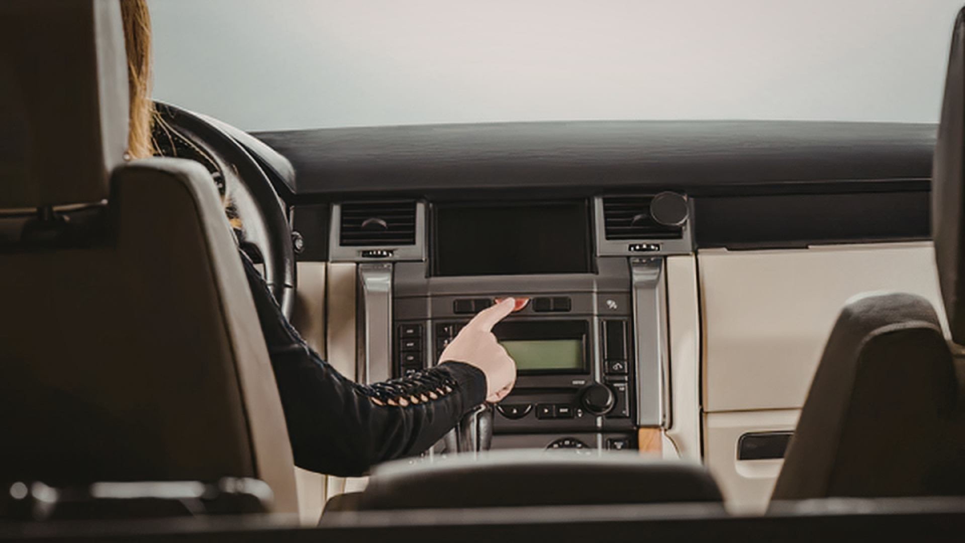 Close-up of a Nissan steering wheel and dashboard inside a car interior.