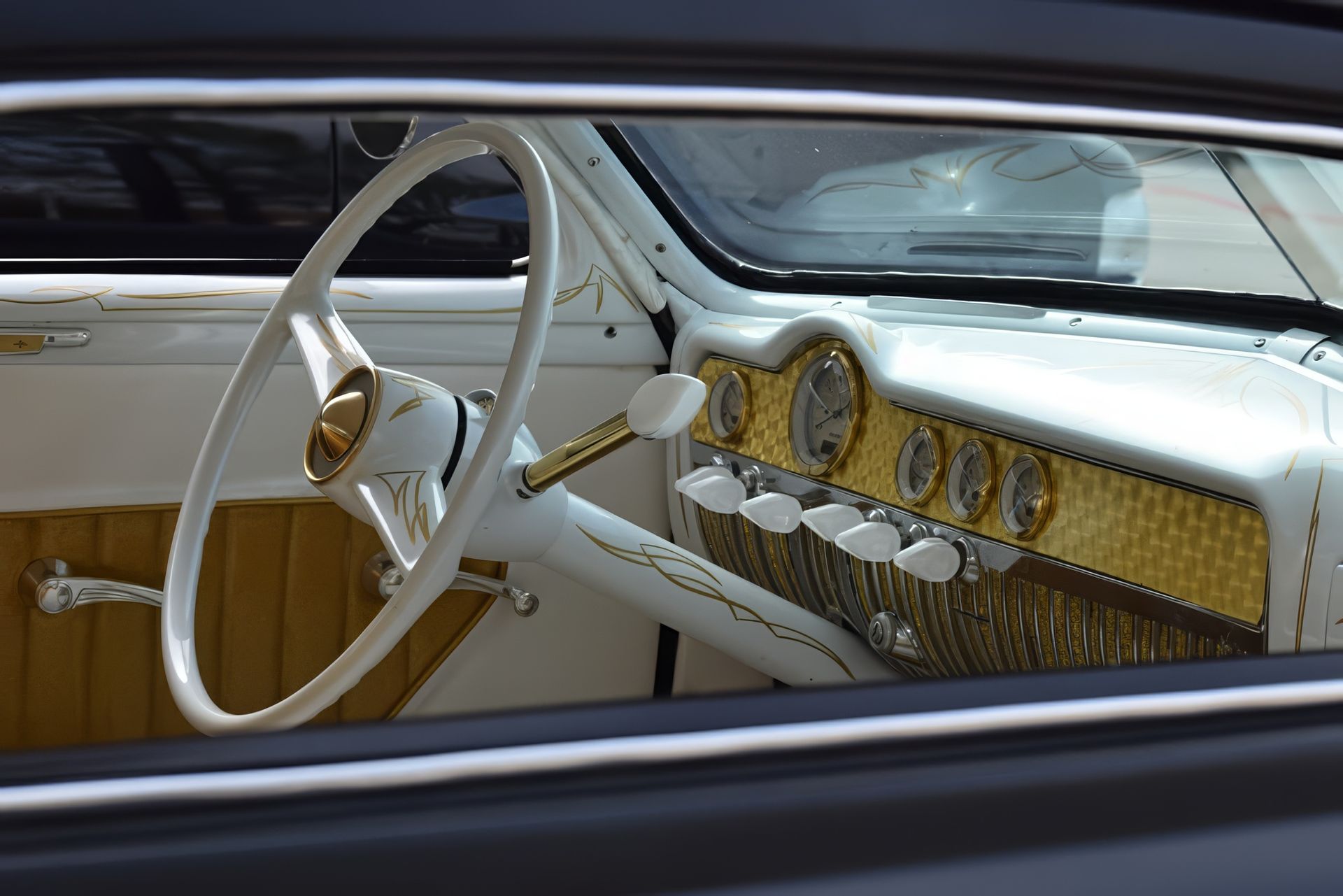 White vintage car interior with gold dashboard and steering wheel