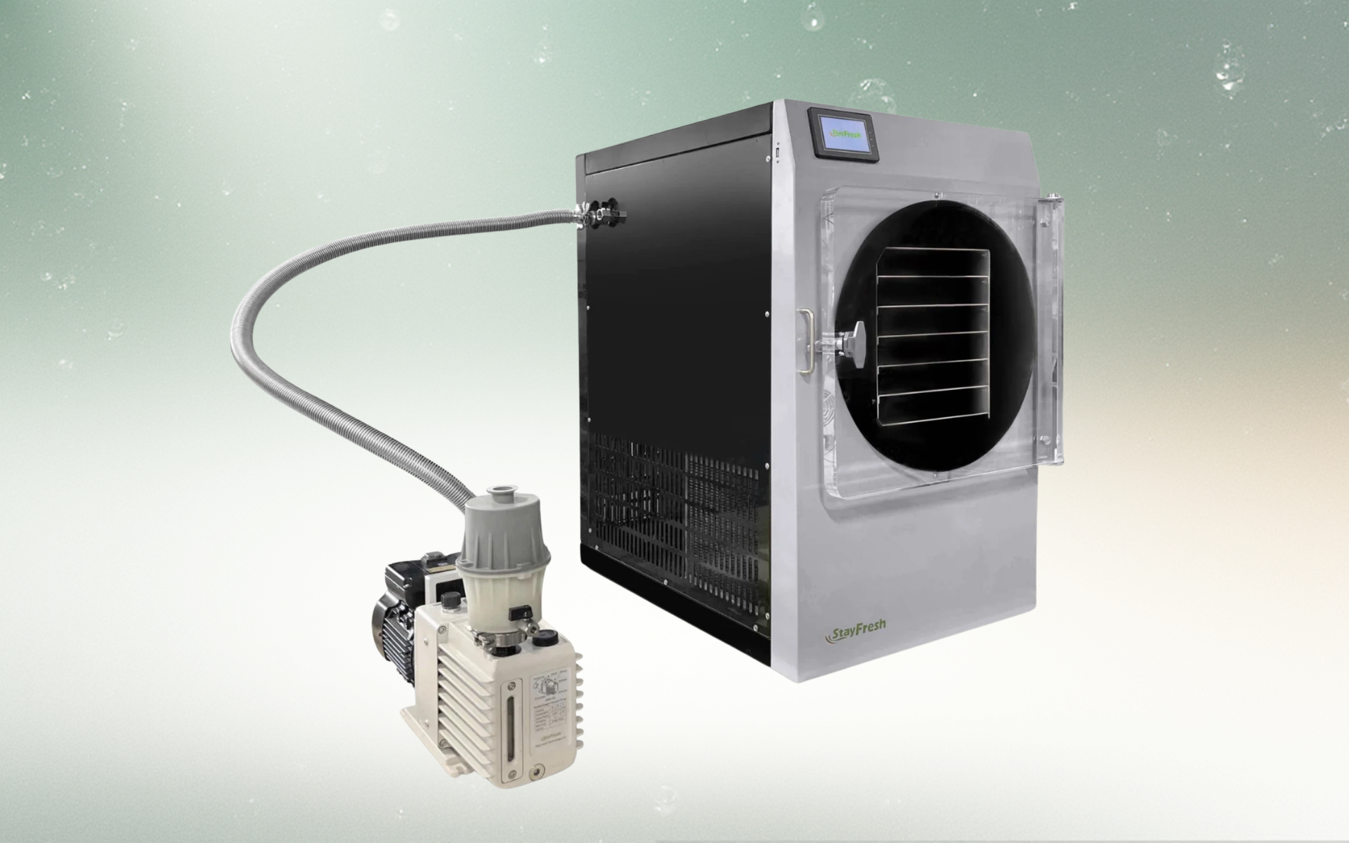 Freeze dryer machine with connected vacuum pump. Stainless steel and black, indoors.