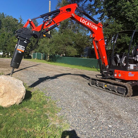 Une excavatrice rouge avec le mot location dessus