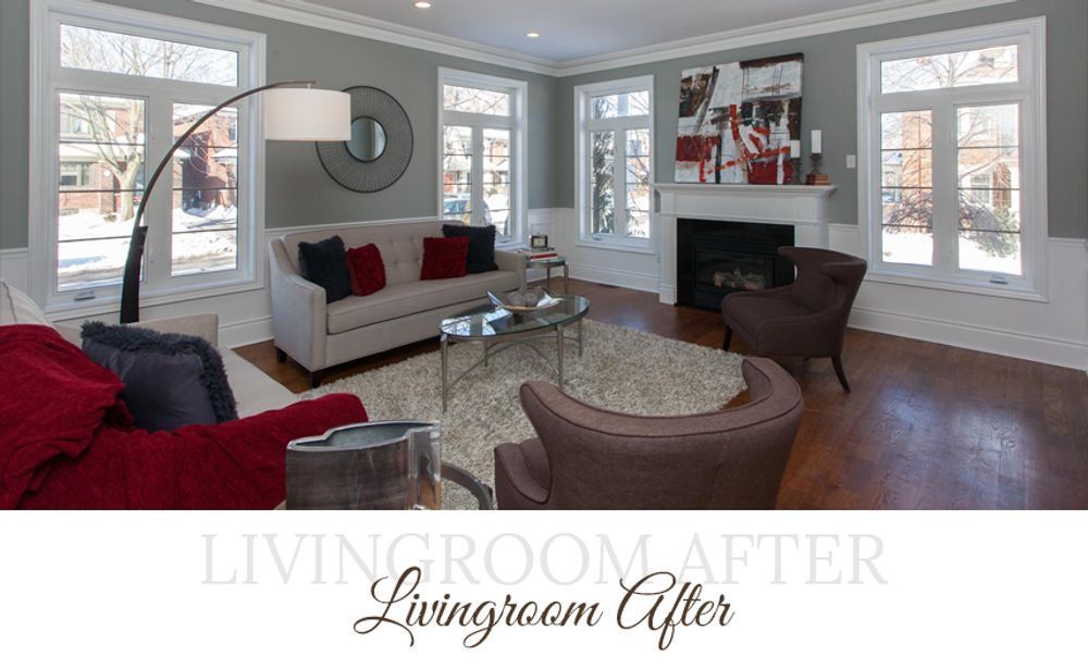 Living room with gray walls, white trim, and hardwood floors; a sofa, chairs, rug, and artwork.