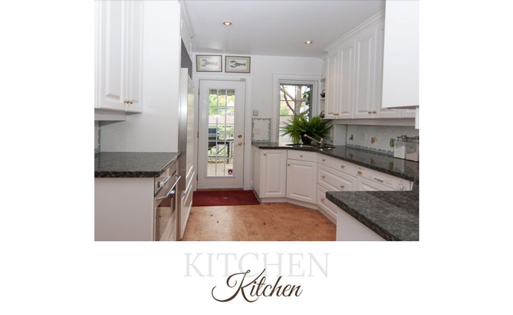 White kitchen with granite countertops, stainless steel appliances, and a door to the outside.