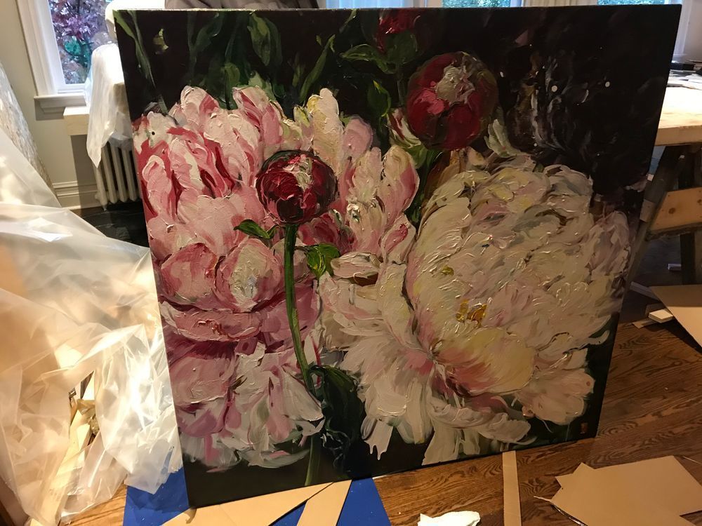 Close-up of a square floral painting with large pink and white peonies against a dark background.