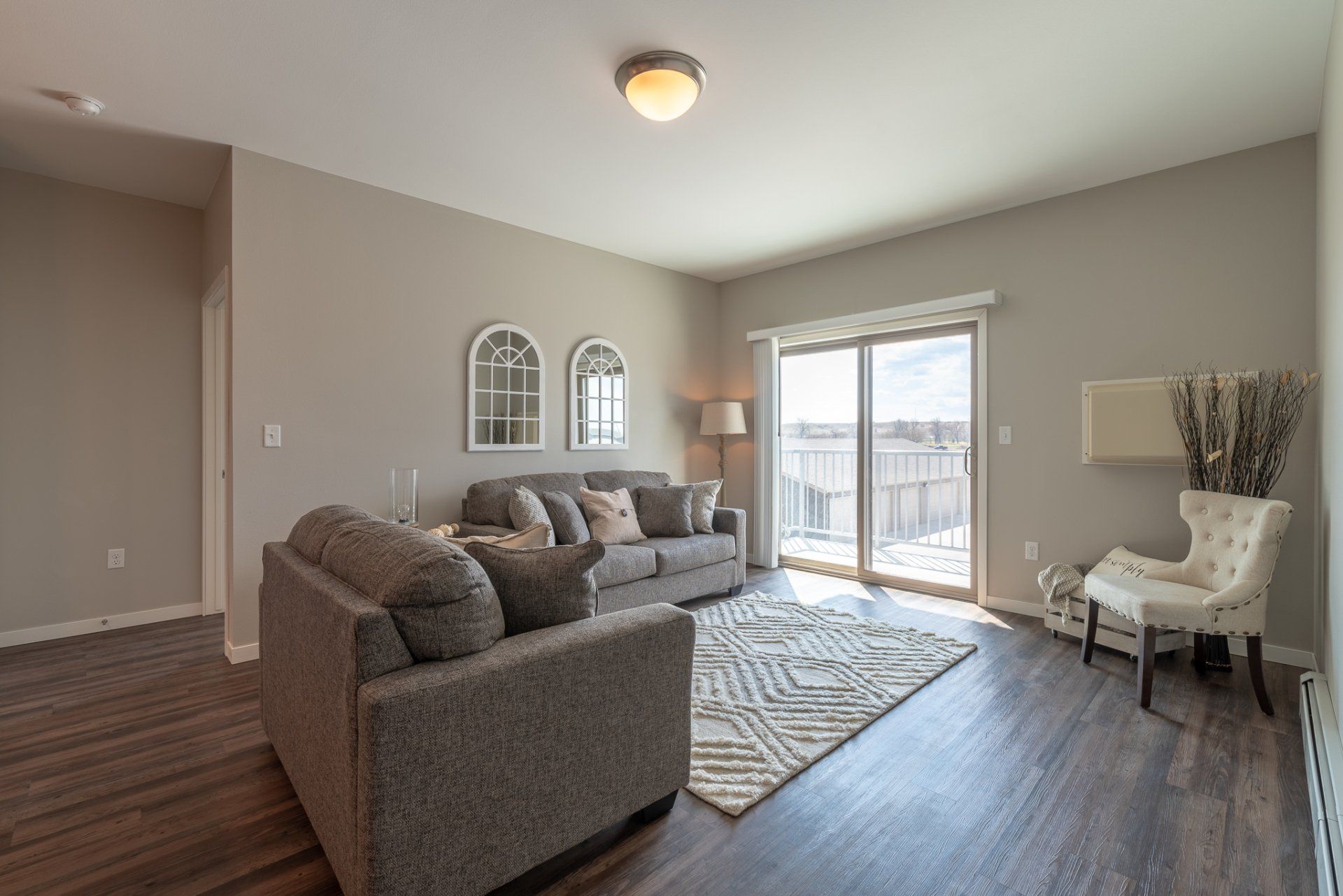 Alternate view of living room with large sliding door leading to balcony