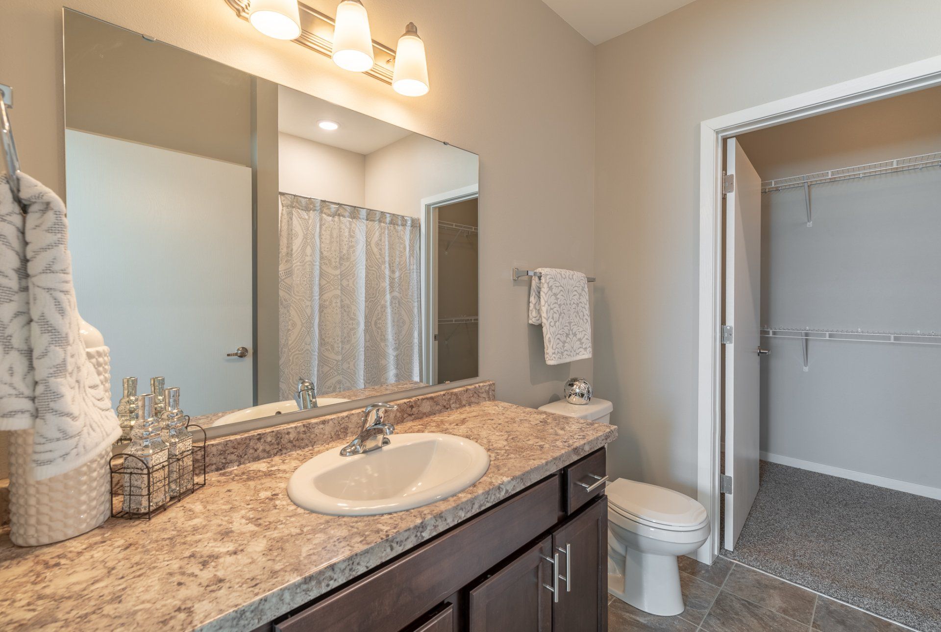 Bathroom sink and toilet looking towards hallway