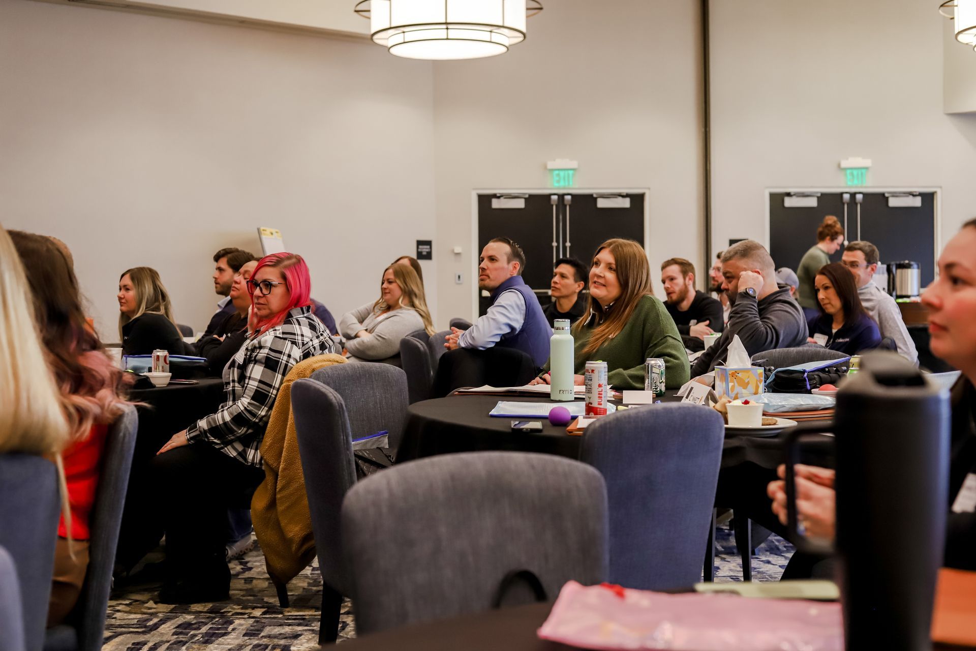 Team members listen to a guest speaker