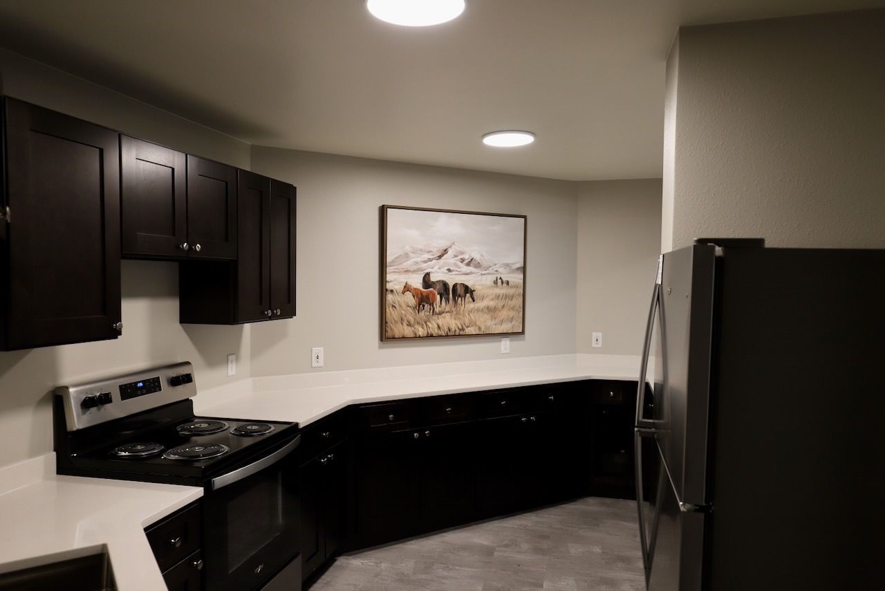 New white countertops, new dark brown cabinets, and new appliances in the kitchen at Dakota Park