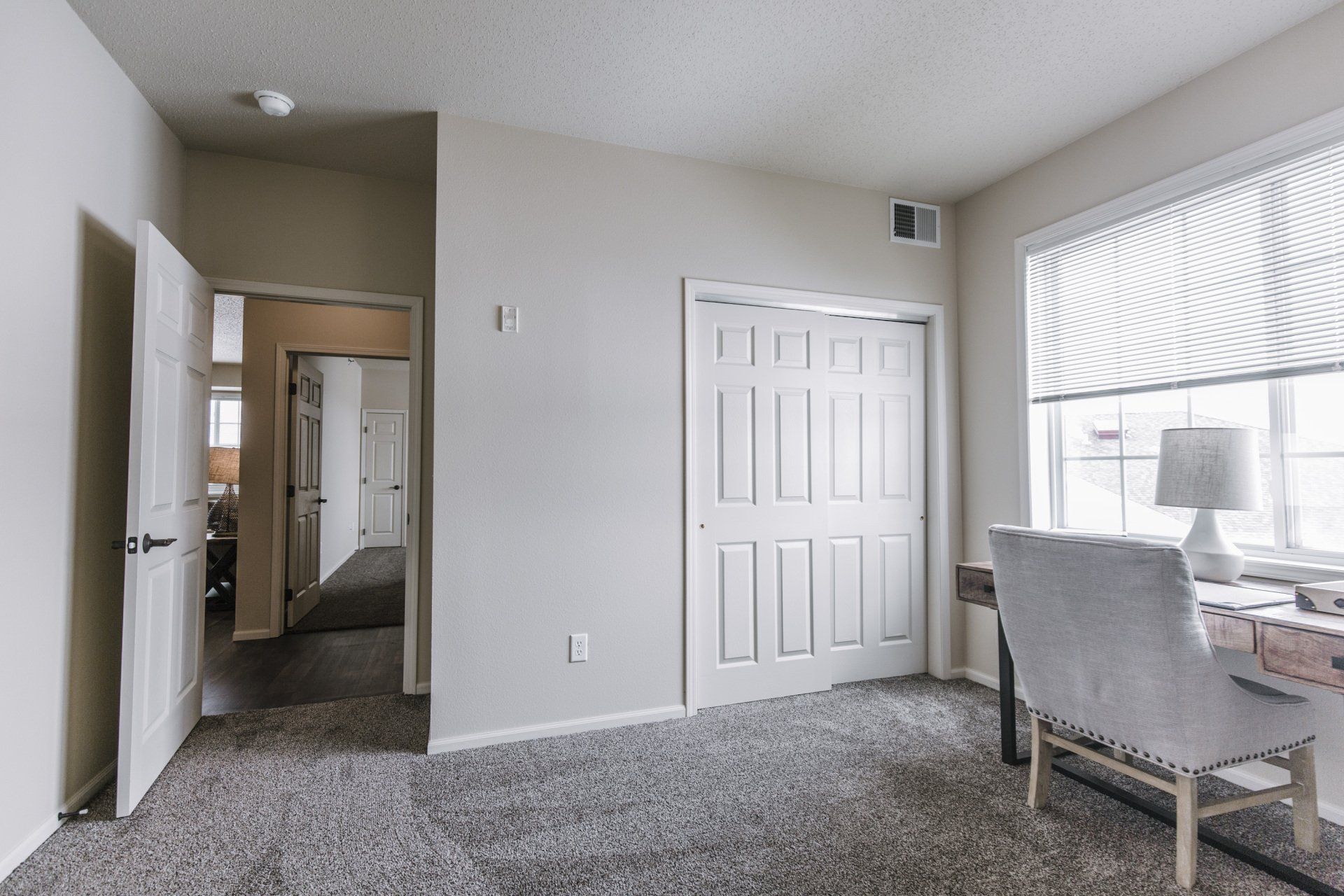 Desk office area with large sliding door closet adjacent